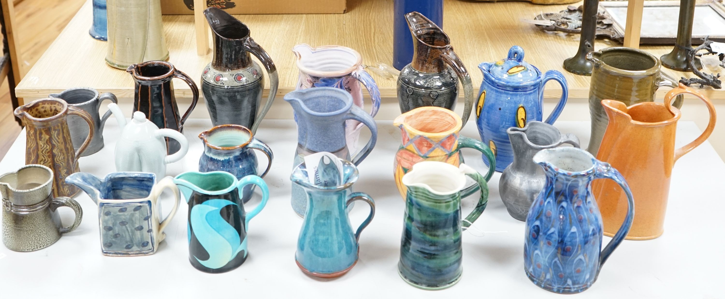 A group of studio pottery jugs to include - 27cm